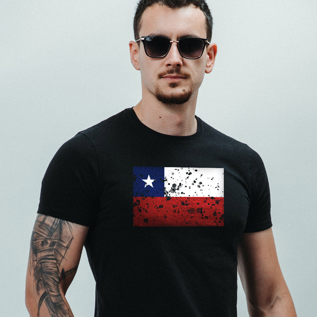 A man with sunglasses wearing a black t-shirt with a Chilean flag on it.